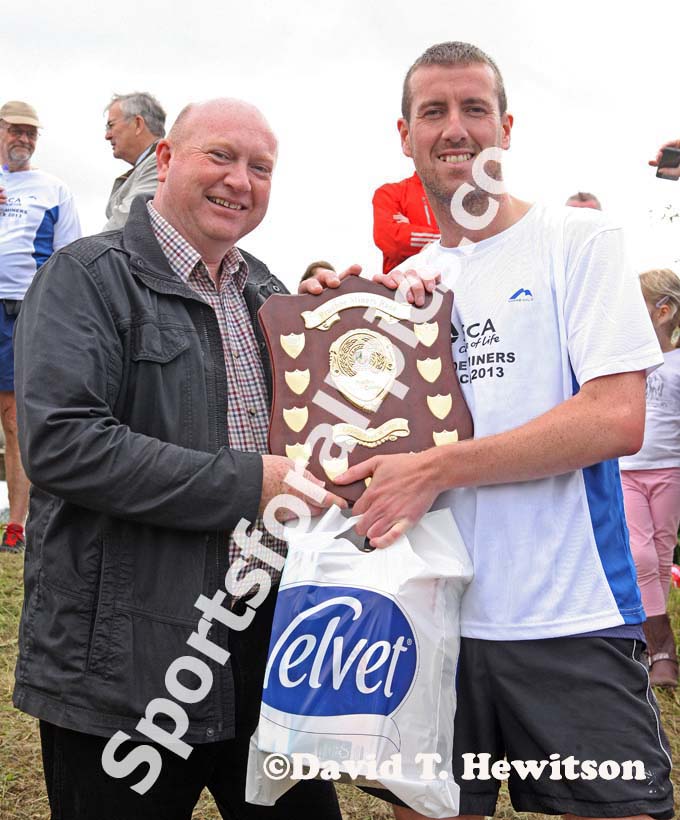 Look North weatherman Paul Mooney presents winner Steve Rankin (Sunderland Stroller) with the Prudhoe Miners Race Trophy.